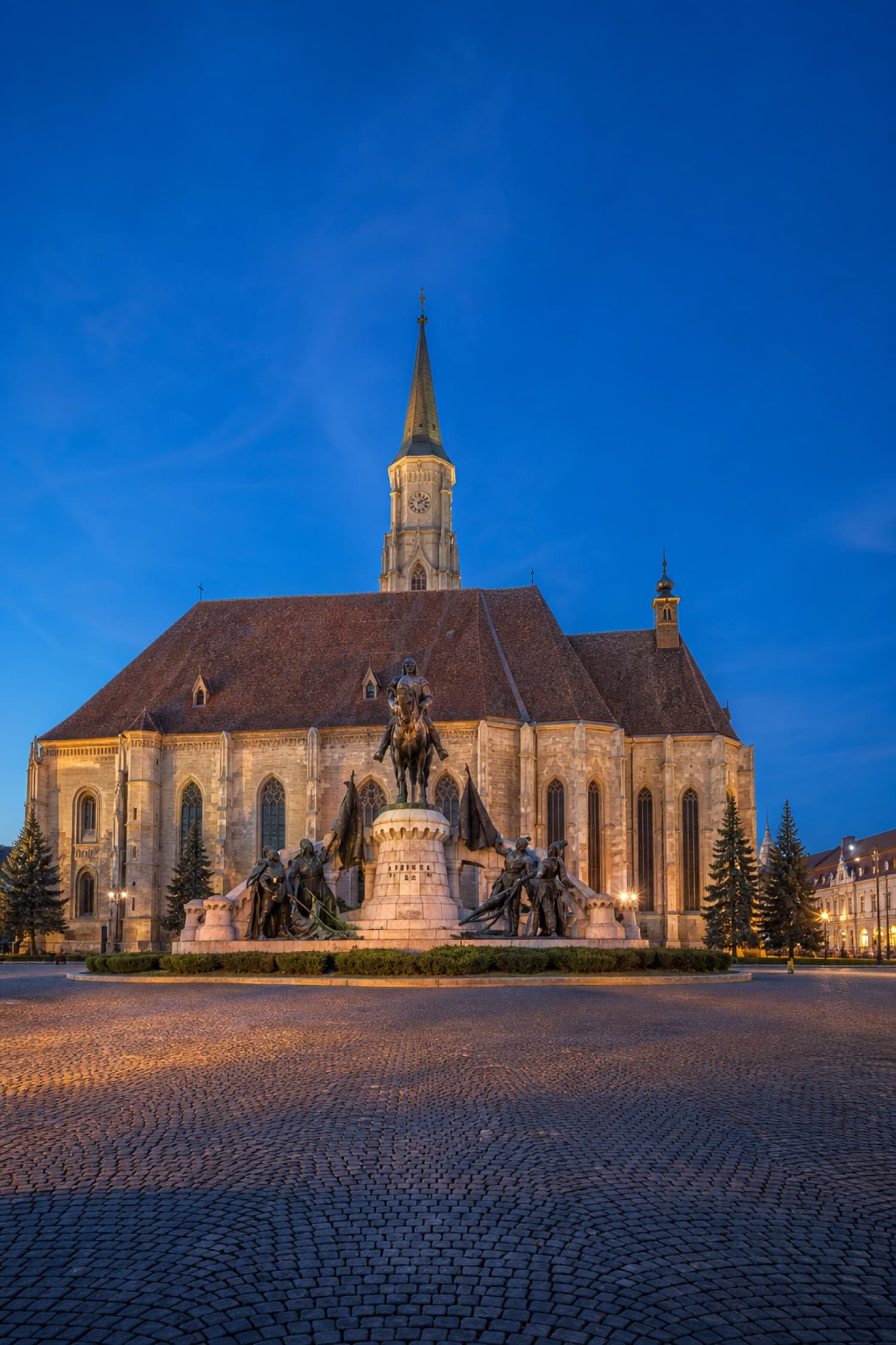 Saint Michael's Church and Matthias Corvinus Monument in Cluj-Napoca at blue hour